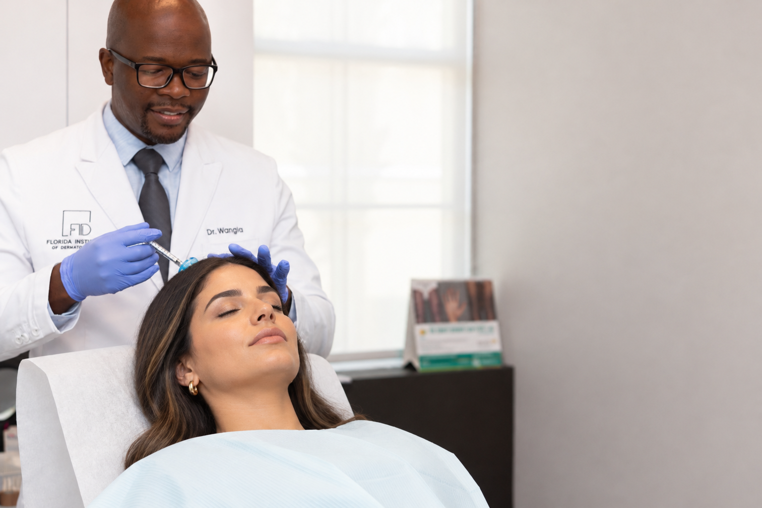 Dr. Michael Wangia treating a patient's scalp at Florida Institute of Dermatology
